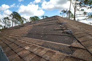 Roof Replacement, Wind Damaged House Roof With Missing Asphalt Shingles