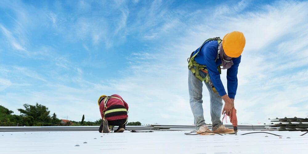 Construction,Worker,In,Work,Clothes,Installing,New,Roofing,Tools,Roofing Construction worker in work clothes installing new commercial roofing tools roofing tools, electric drill, and use on new wooden roofs with metal sheets