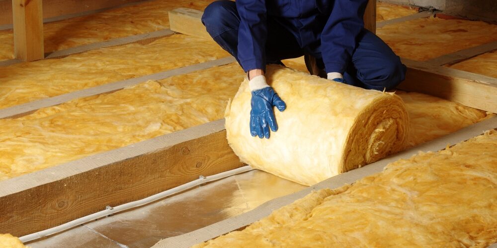 Construction,Worker,Thermally,Insulating,House,Attic,With,Glass,Wool Construction worker thermally proper insulation house attic with fiber glass wool