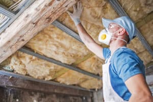 Old Roof Proper Insulation Worker Inspecting Roof and Mineral Wool Insulation