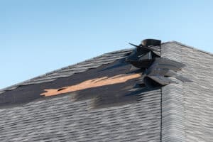 Roofing Problems. Damaged shingles on roof.