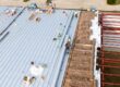 commercial roofing trends. Men roofing a new commercial roof.
