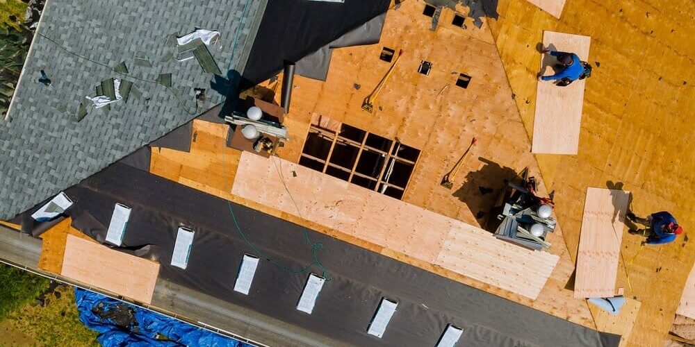 Roof Replacement. Roofers Nailing Shingles With Air Gun Replacing Roof Cover. Roof Replacement. Roofers Nailing Shingles With Air Gun Replacing Roof Cover.