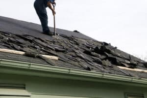roof replacement. Removing Old Shingles To Prepare A Roof For New shingles.