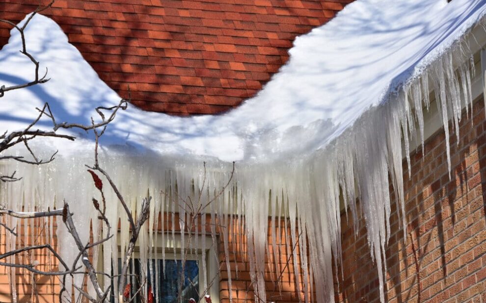 Ice Dams. Ice Build Up In Roof Gutters Creating A Dam.