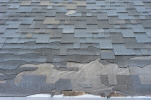 Roof Needs Repair. Close Up View Of Shingles Roof Damage.