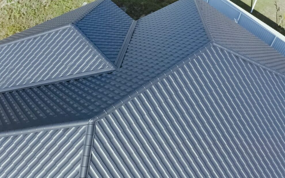 Metal Shingle Roof. House With A Gray Metal Roof.