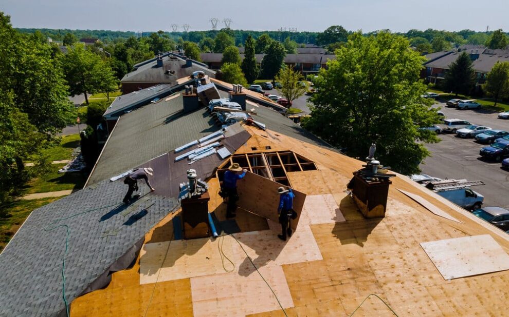 Roof Replacement. Roof Shingles Need With New Shingles On A home roof.
