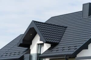 Metal Shingle Roof. A Beautiful Modern House Is Covered With Black Metal shingles.