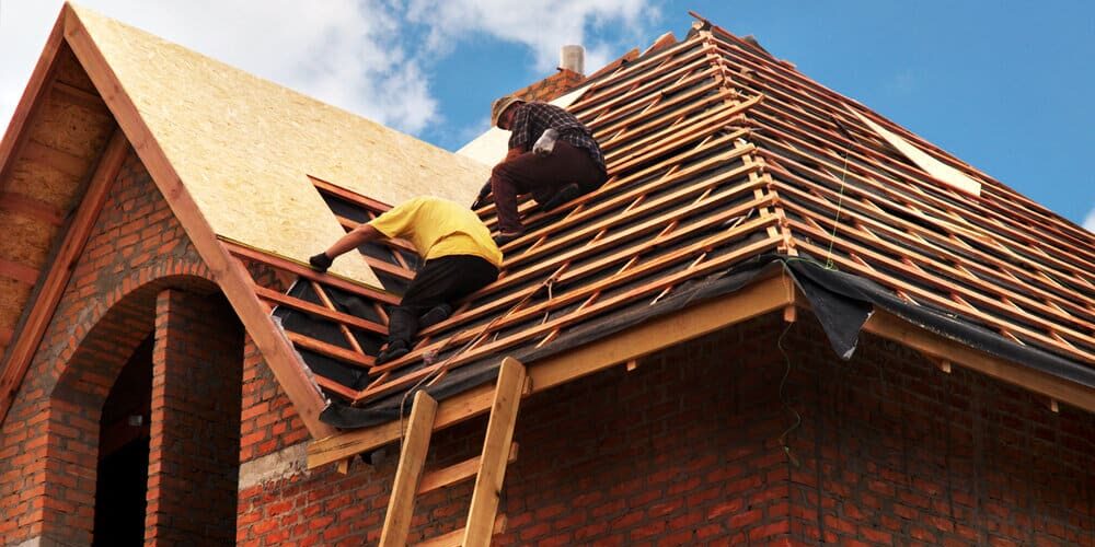 Roof Contractors. Roofing Contractors Installing House Roof Board For Asphalt Shingles Roofing. Roof Contractors. Roofing Contractors Installing House Roof Board For Asphalt Shingles Roofing.