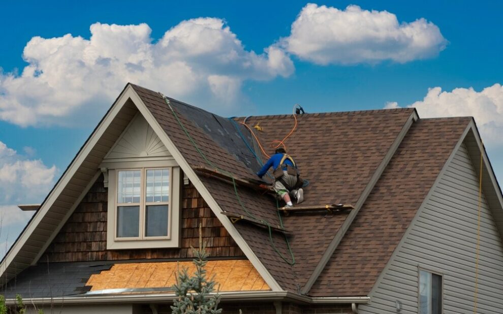 Roof Repair in Ottawa. A Worker Moves Along The roof To Repair roof.