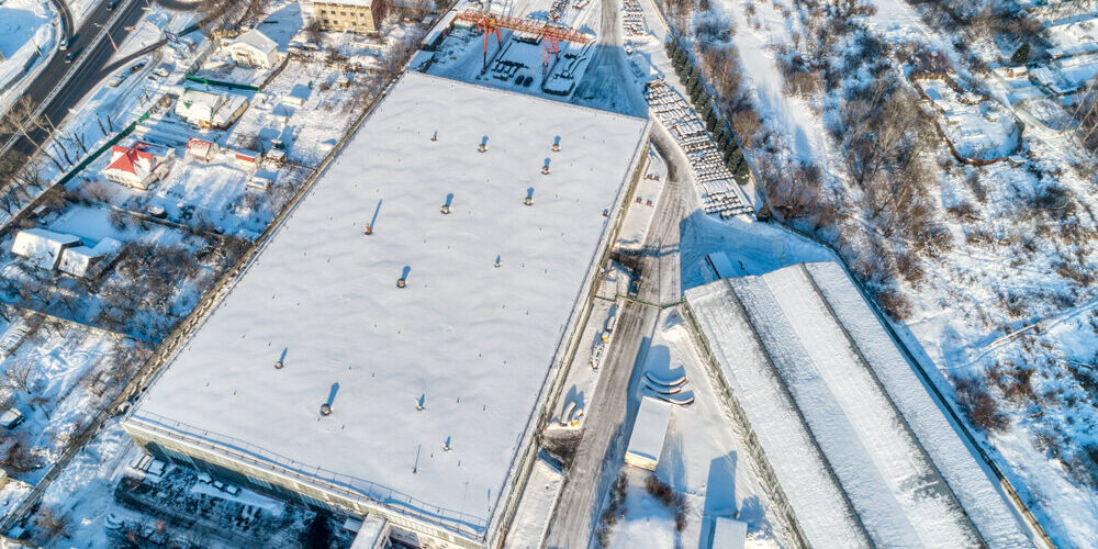 Large,Warehouse,Hangar,,Industrial,Zone,Of,The,City.,Sunny,Winter commercial roofing. Large,Warehouse,Hangar,,Industrial,Zone,Of,The,City.,Sunny,Winter