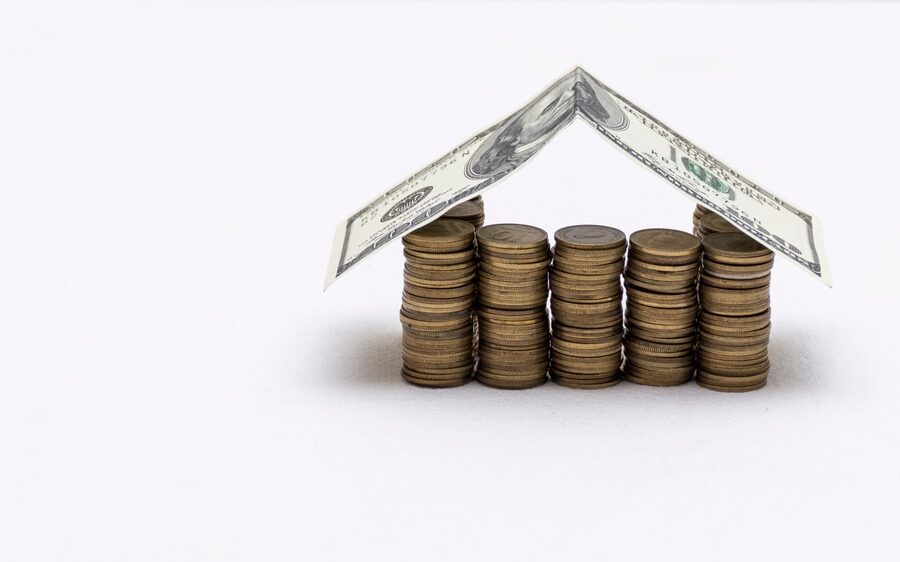 What Factors Affect the Cost of Roofing in Ottawa? House made with coins and a roof of dollar bills.