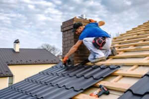 What Makes Godfrey Roofing Ottawa’s Premier Roof Contractor? Roofing Materials. a professional master (roofer) with electric drill installing metal roofing.