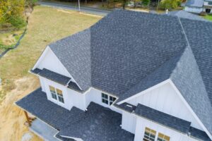 Roof Contractor. Asphalt shingles cover the roof of a newly constructed house.