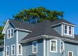 Residential Roofing. Beautiful family house with blue siding and white trim. new roof.