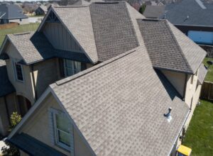 How Our Specialty Roof Systems Can Enhance Your Property. Residential shingle roof using ridge vent s with gables visible.