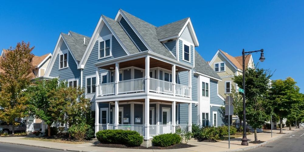 Charming,Two-story,Corner,House,With,A,Classic,New,England,Architectural How Our Specialty Roof Systems Can Enhance Your Property. Charming two-story corner house with a classic New England architectural style.