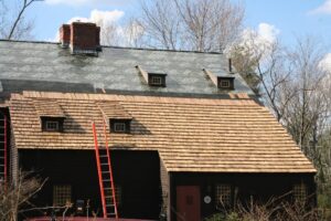 Why Is Cedar Roof Replacement Popular in Ottawa? Installing a cedar shake roof. ladders and staging. Underlayment and ventilation on house.
