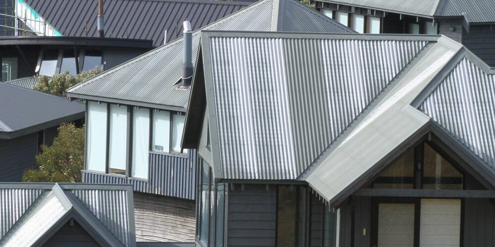 Abstract,Multiple,Grey,Tin,Roofs,Of,All,Shapes,And,Sizes What Roof Types Are Popular in Ottawa Roofing Projects? Abstract multiple grey tin roofs of all shapes and sizes on a group of houses.