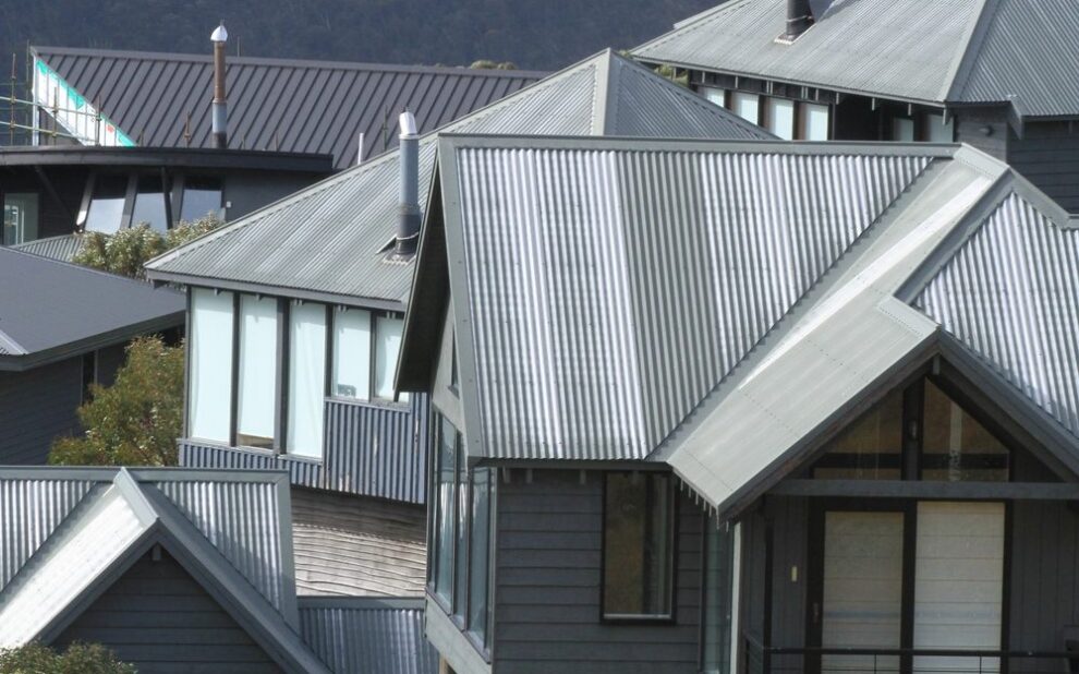 What Roof Types Are Popular in Ottawa Roofing Projects? Abstract multiple grey tin roofs of all shapes and sizes on a group of houses.