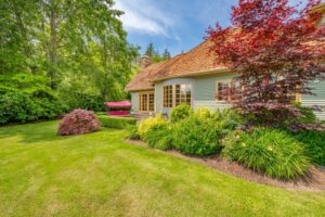 What Roof Types Are Popular in Ottawa Roofing Projects? Cedar Shake Roofs. Large luxury home with manicured landscaping bright blue skies wispy white clouds in the sky featuring front door entryway inviting views.