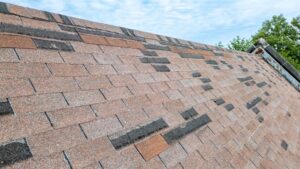 When Should Ottawa Homeowners Replace Shingle Roofs? Roof in need of repair, missing shingles from storm damage.