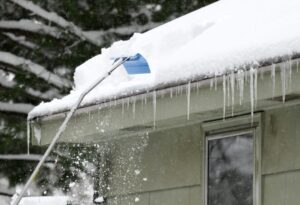 How Ottawa’s Harsh Winters Affect Your Roof & What To Do About It? removing snow on the roof after snow storm.