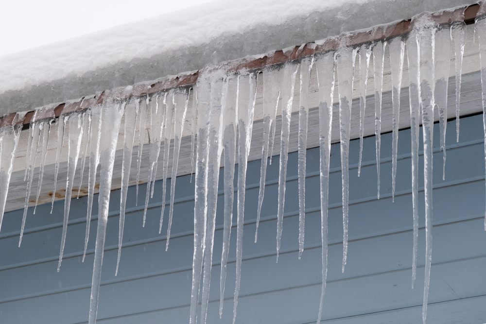 How Ottawa’s Harsh Winters Affect Your Roof and What To Do About It. Icicles cascading from a roof.