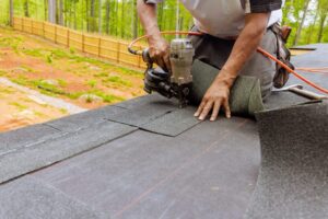 7 Warning Signs You Need Professional Roof Repair Inspections. Installation of new asphalt shingles repairing a leak, using an air pneumatic nail gun by roofer.