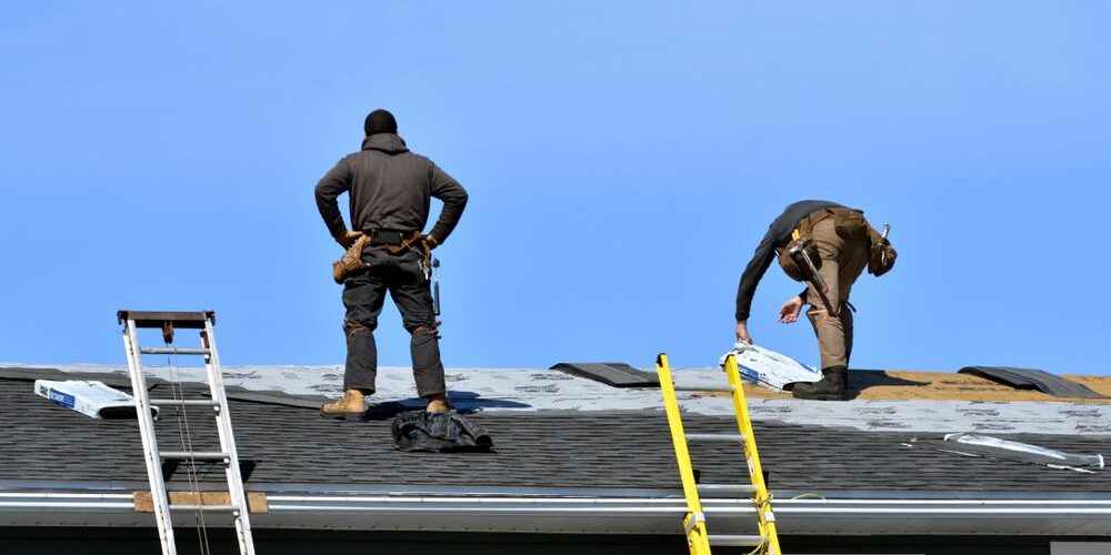 Finding the Best Roofing Contractors Near You: A Guide for Ottawa. Two Men Roofing a House in the Sun in Spring.