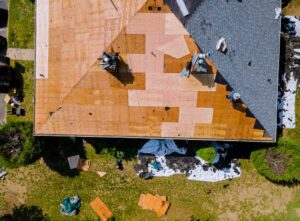 The Comprehensive Guide to Roof Replacement for Ottawa Homeowners in 2026. Removal of the old roof and replacement with new shingles of an apartment building.