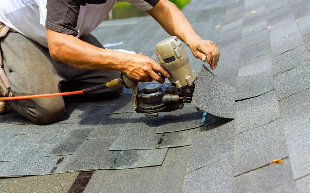 Roof Repair vs. Roof Replacement in Ottawa: How to Know What You Need. During installation of new bitumen shingles, construction roofer used pneumatic air nail gun.