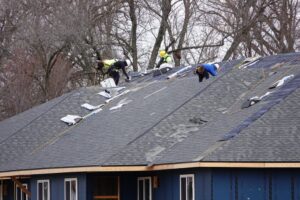 Ottawa Residential Roofing Upgrades: Local Trends & Solutions. Men shingling the roof. 