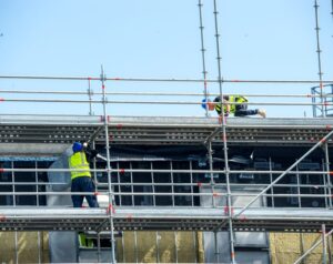 Plan a Commercial Roofing Project Timeline Without Disruption. a construction site with scaffolding.