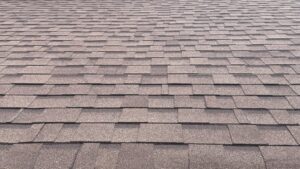 Compare Roofing Materials for Homes in Ottawa: Durability, Cost, & Aesthetics. A detailed shot of overlapping gray roof shingles, forming a uniform, textured pattern that extends across the entire surface.