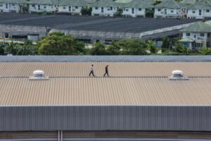 The Step-by-Step Process Commercial Roof Contractors Use for Large-Scale Roof Replacement. Engineer inspects the factory roof.