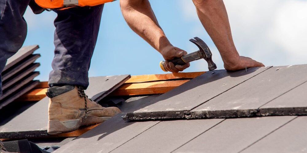Choose the Best Residential Roofing for Your Ottawa Home Renovation. Construction worker roofers installing roofing tiles on residential building.