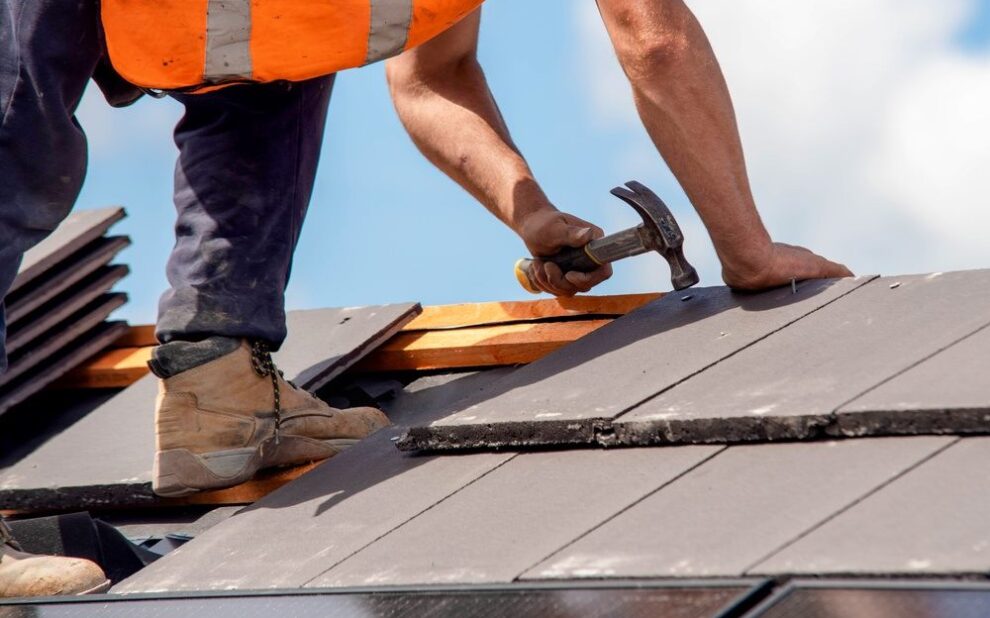 Choose the Best Residential Roofing for Your Ottawa Home Renovation. Construction worker roofers installing roofing tiles on residential building.